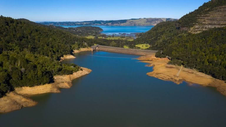Water reservoir in forest valley